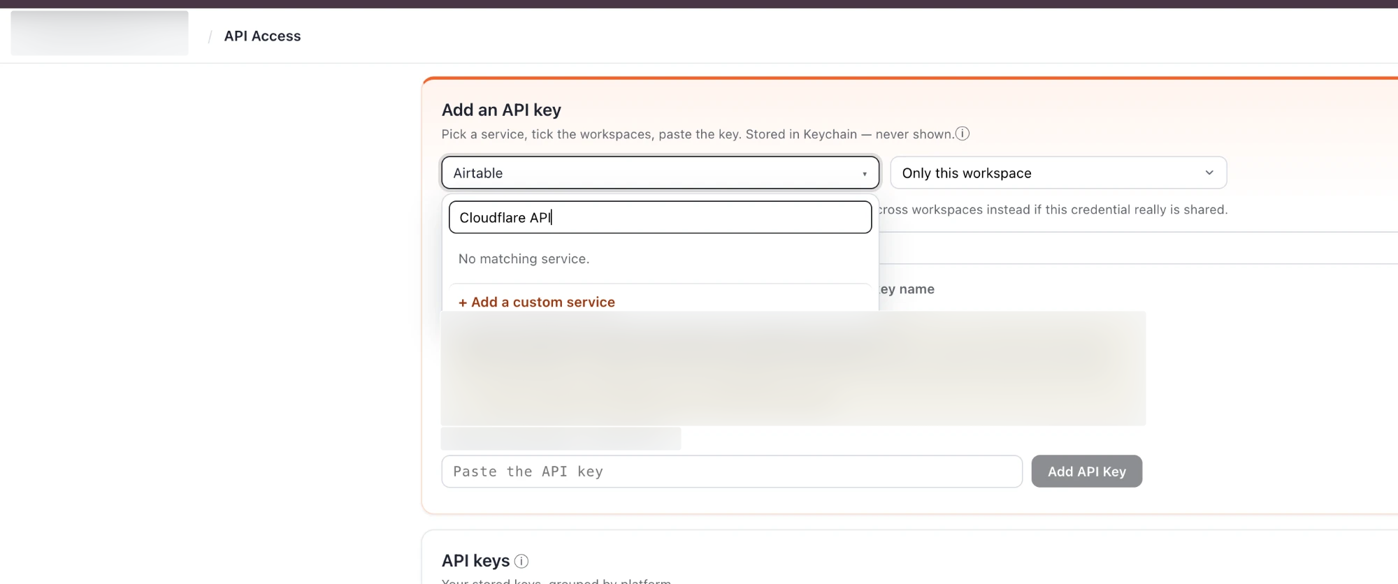 Search for Cloudflare API and choose Add a custom service. The client Workspace and identifying text are blurred.